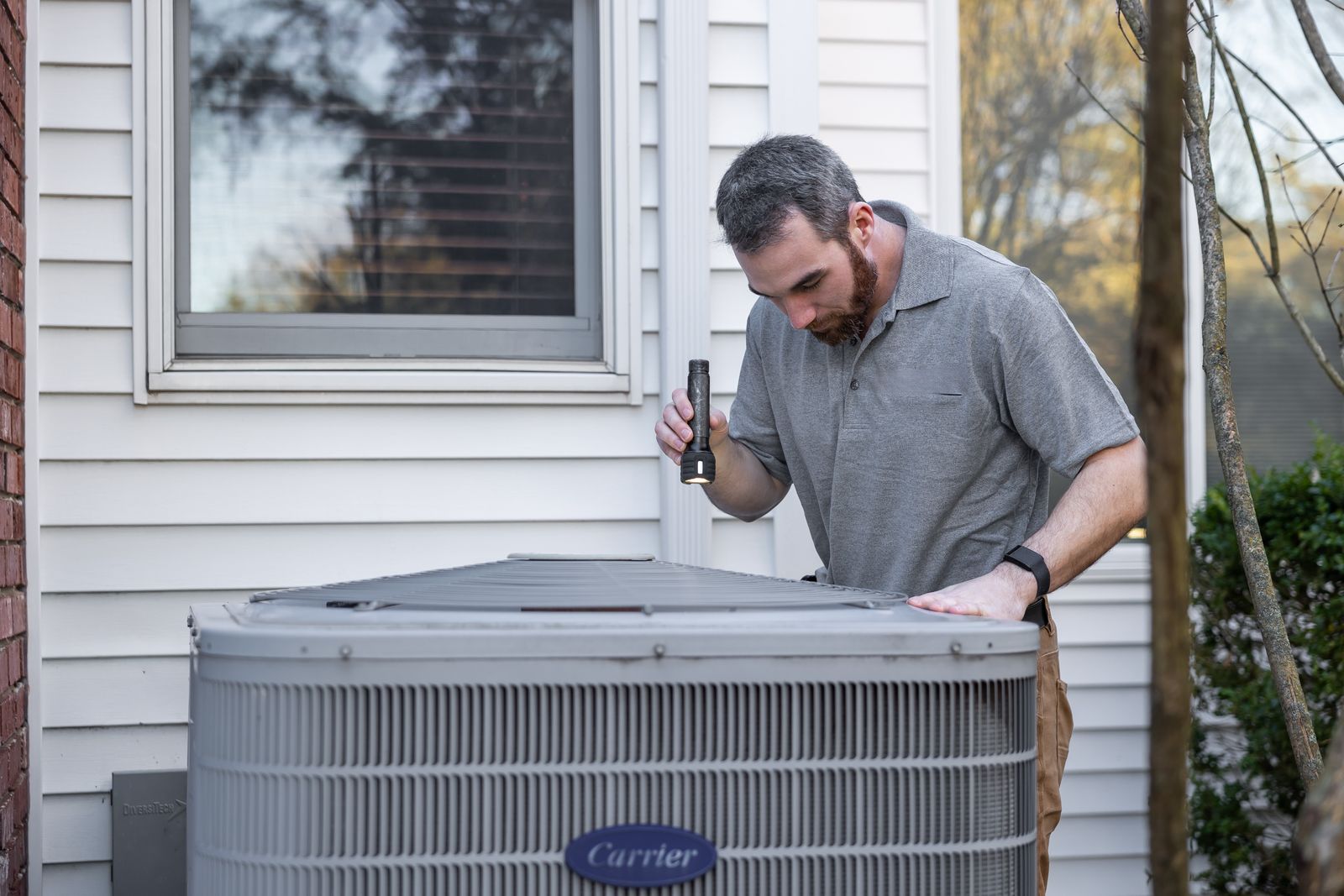 HVAC technician inspecting an indoor air handling unit
